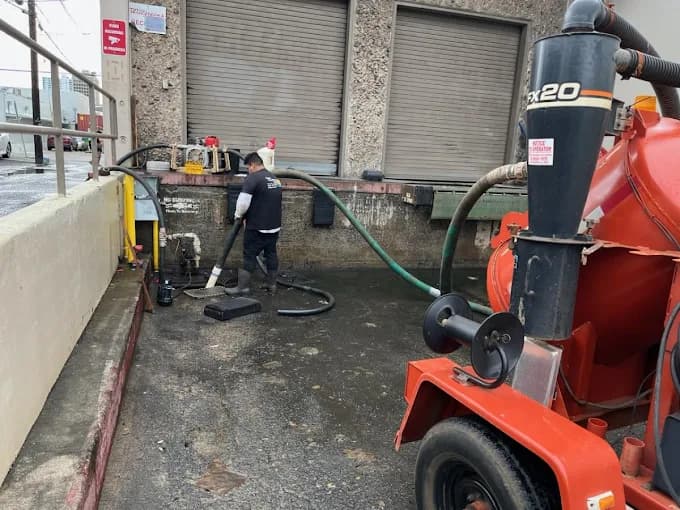 Tech clearing a clogged drain